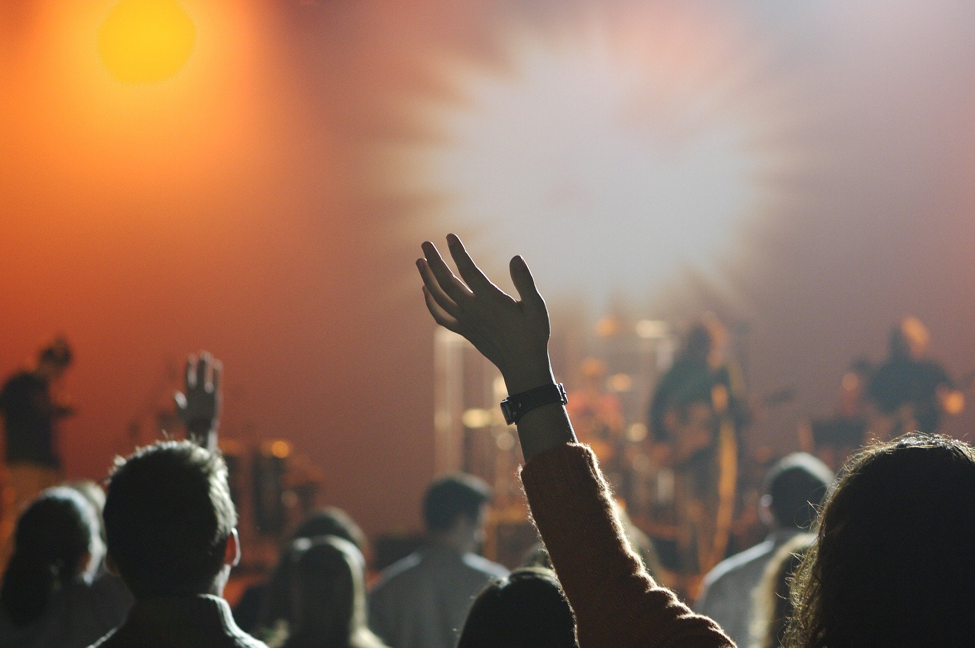 a raised hand in front of a stage